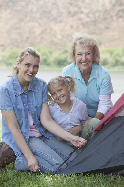 Femme avec mère et fille érigeant une tente
 - Photo, image
