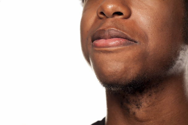 Smile closeup of a young black African american guy on white background - Φωτογραφία, εικόνα