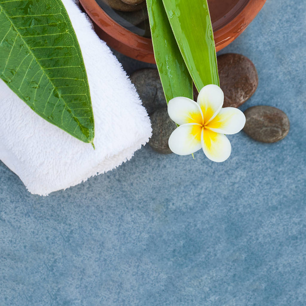 Spa set with tropical flower for relax body massage treatment on blue background. - Photo, Image