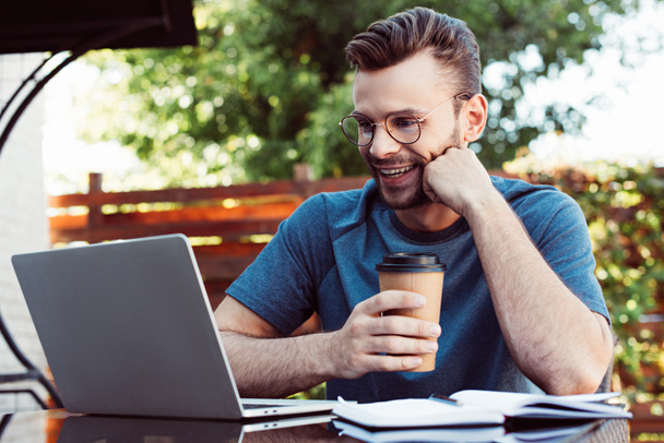 happy handsome man taking part in webinar outdoors - Photo, Image