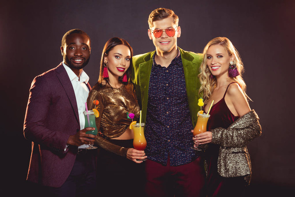 smiling glamorous multiethnic friends with alcohol cocktails on party - Фото, зображення