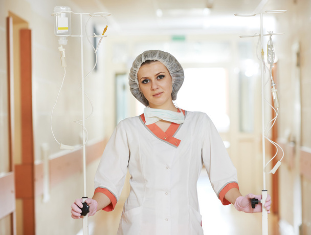 Young medic nurse with droppers in hospital - Zdjęcie, obraz