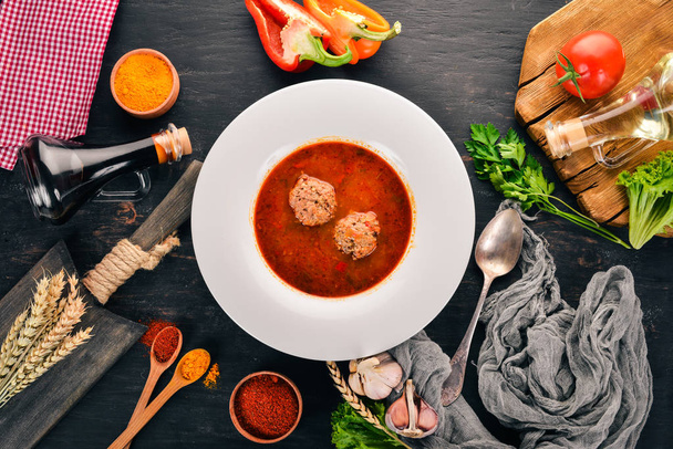 Vegetable soup with meat balls. On the old wooden background. Free space for text. Top view. - Foto, Imagem