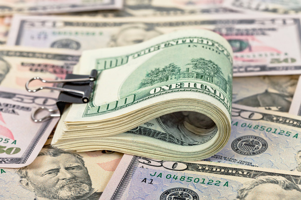 Folded hundred dollar bill on money background - Fotó, kép