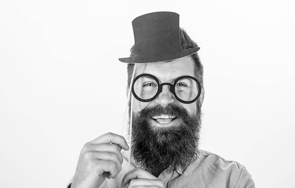 Man bearded hipster hold cardboard top hat and eyeglasses to look smarter white background. Dress affects how people see you. Guaranteed ways appear smarter. Tricks to seem smarter. Dress for success - Photo, Image
