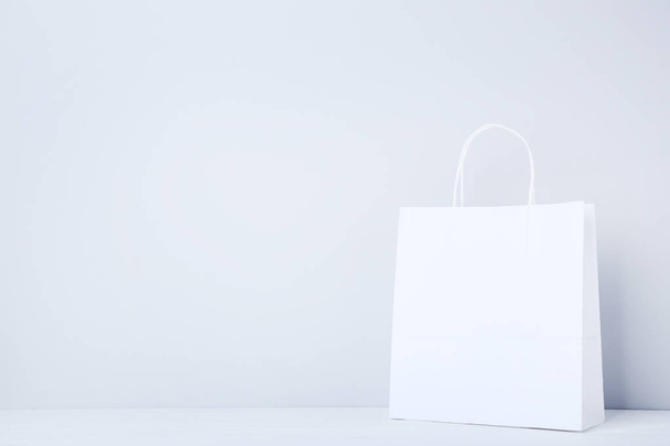 Paper shopping bag on grey background - Fotoğraf, Görsel