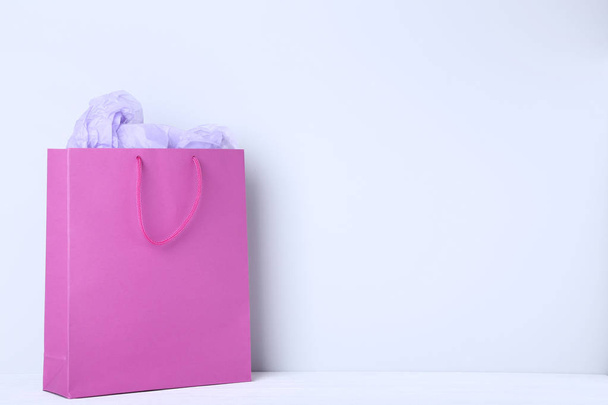 Pink shopping bag with paper on grey background - Fotoğraf, Görsel
