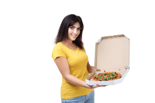 Young woman with pizza in cardboard box on white background - Фото, зображення