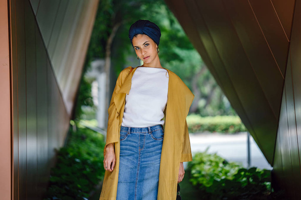Fashion portrait of a tall, slim, young and attractive Malay Muslim woman wearing fashionable clothing and a turban - Photo, image