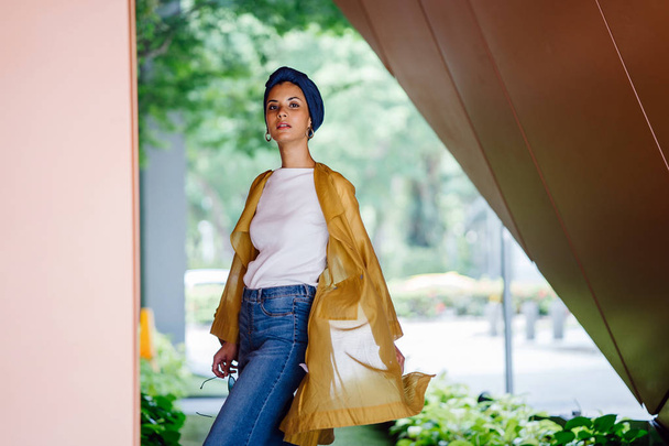 Fashion portrait of a tall, slim, young and attractive Malay Muslim woman wearing fashionable clothing and a turban - 写真・画像