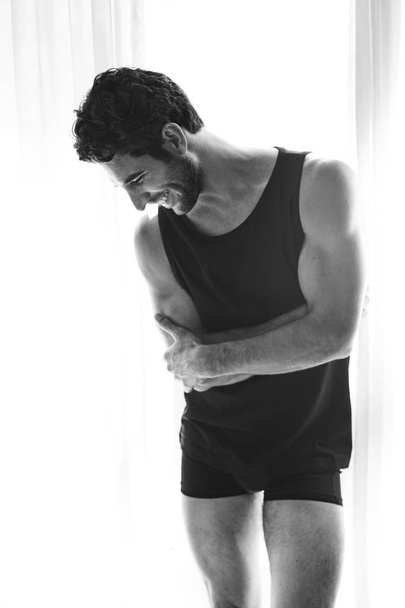 Guy in underwear laughing and looking down - Foto, immagini