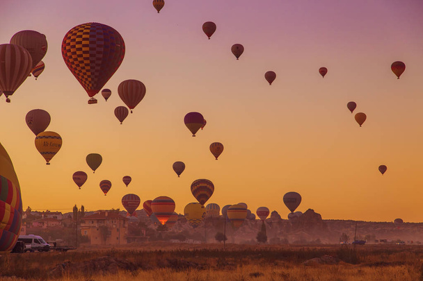 Central Anatolia, Goreme, Turkey - September 21, 2018. Amazing sunrise over Cappadocia. Colorful hot air balloons.  - Фото, изображение