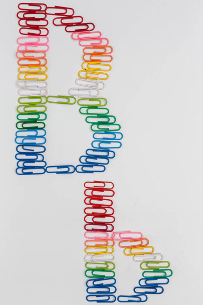 Alphabet B made from color paper clips on white background. - 写真・画像