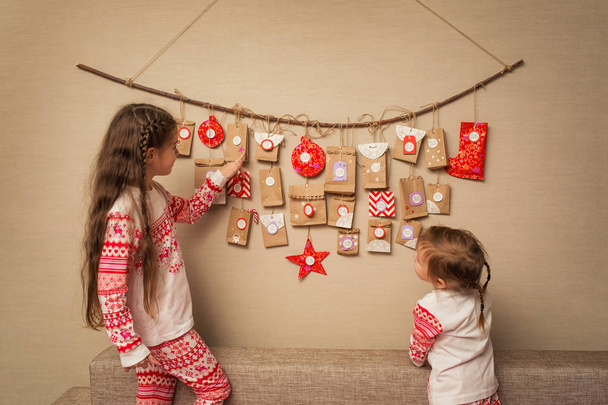 children look at advent calendar. option DIY to wait for Christmas for kids. - Фото, изображение