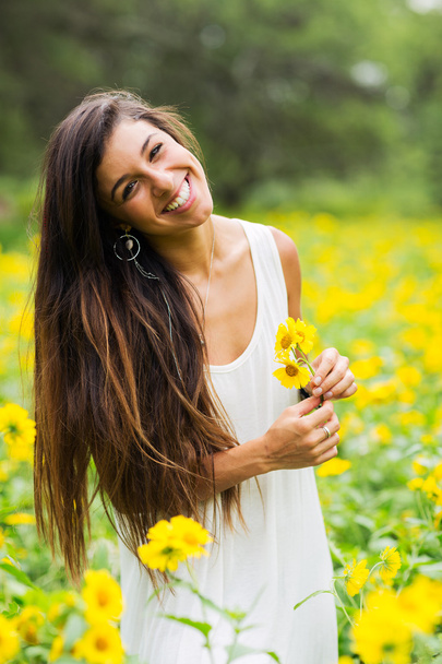 woman in field of flowers - Фото, изображение