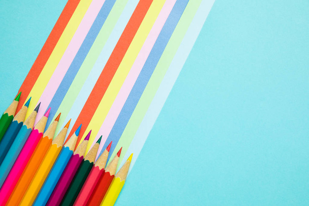 colored pencils and rainbow colorful stripes, stationary - Фото, изображение