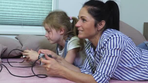 Daughter and mother playing computer game at home - Filmagem, Vídeo