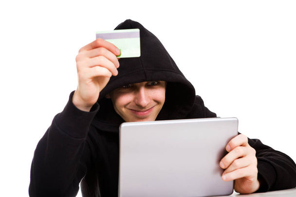 Cheerful Hacker with a Tablet Computer and Bank Card on the White Background - Foto, Bild