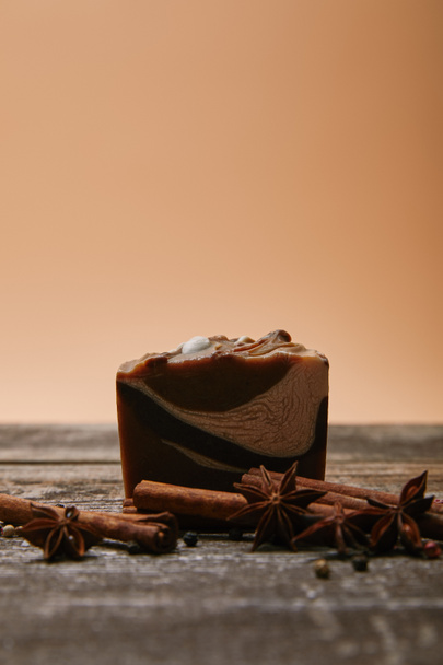 close-up shot of soap with spices on rustic wooden tabletop - Фото, зображення