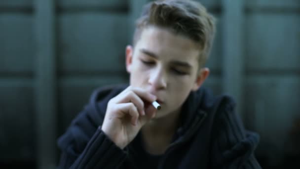 Teenager smoking cigarette, hiding from parents, bad habits, awkward age - Materiaali, video