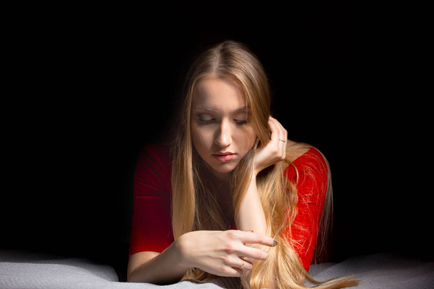 Portrait of a beautiful blonde girl with long hair. Emotions thinking and calm mood. Pretty woman. - Photo, Image