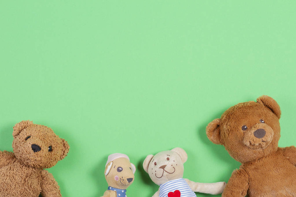 Top view with soft baby toys on green background - Фото, изображение