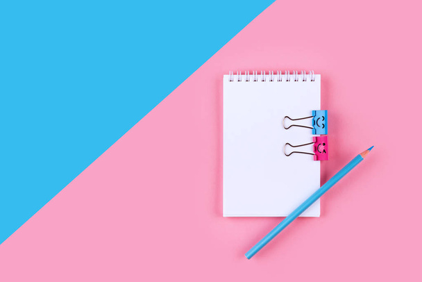 Top view of Blank notebook on colorful background pink blue with copy space. - Valokuva, kuva