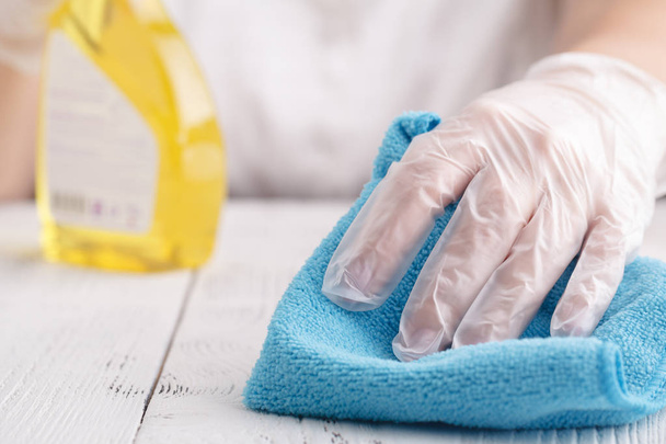 Hand in a protective glove with a washing sponge and spray sprinkle - Фото, изображение