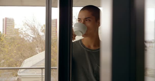 Young man having coffee at home 4k - Filmagem, Vídeo