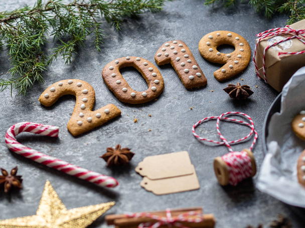 Ginger Christmas or New Year cookies in the form of numbers 2019 on a dark background . - Fotoğraf, Görsel