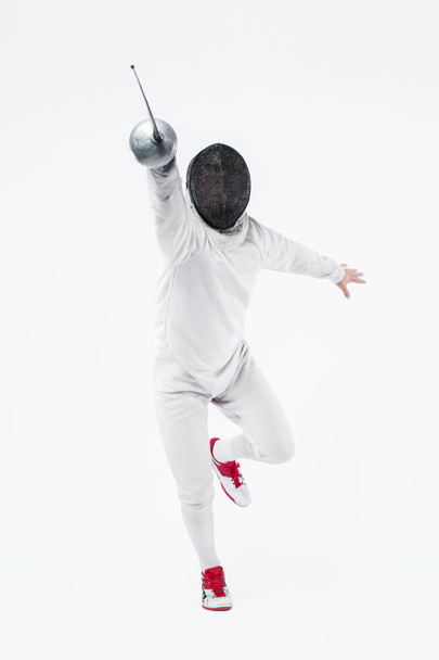 Young fencer athlete wearing mask and white fencing costume. holding the sword. Isolated on white background - Foto, Imagem