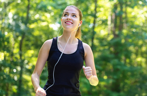 Athletic young woman jogging - Fotó, kép