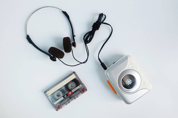Retro cassette tape and Portable tape player with radio on white floor, top view - Фото, изображение