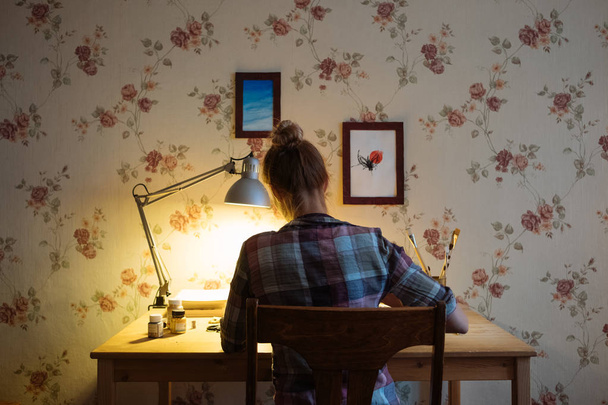 A place to work at home. Girl working at home at a wooden table - 写真・画像