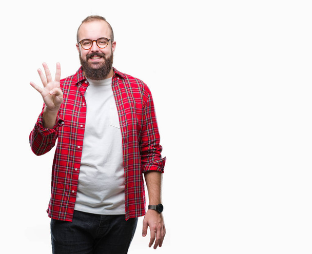 Young caucasian hipster man wearing glasses over isolated background showing and pointing up with fingers number four while smiling confident and happy. - 写真・画像