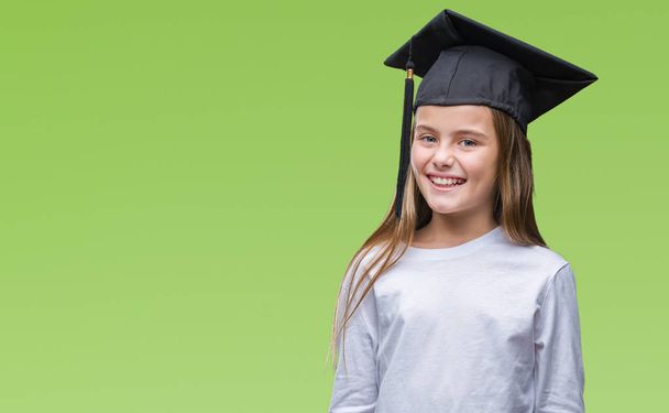 Young beautiful girl wearing graduate cap over isolated background with a happy and cool smile on face. Lucky person. - Foto, Imagen