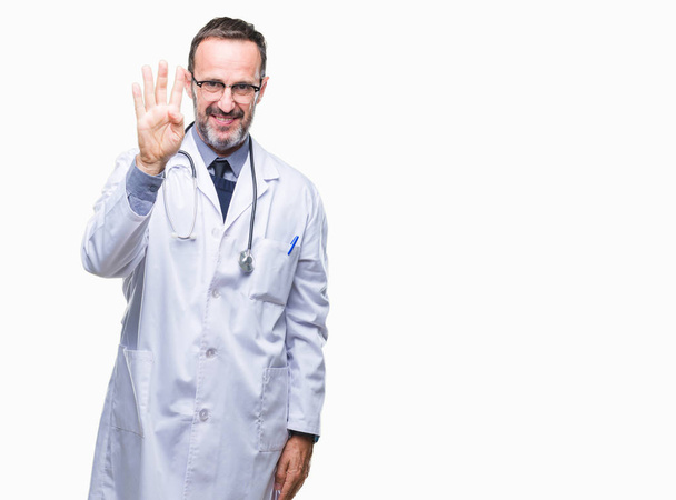 Middle age senior hoary doctor man wearing medical uniform isolated background showing and pointing up with fingers number four while smiling confident and happy. - Фото, зображення