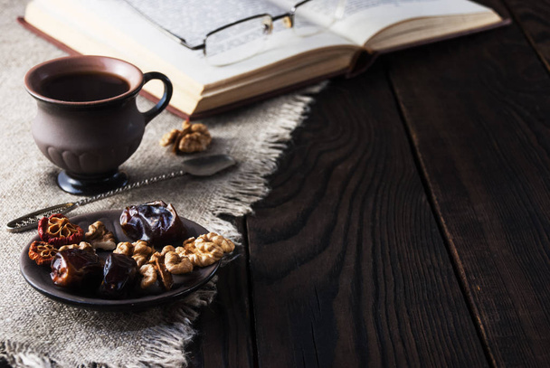 Cup of coffee and book on a wooden table - Photo, Image