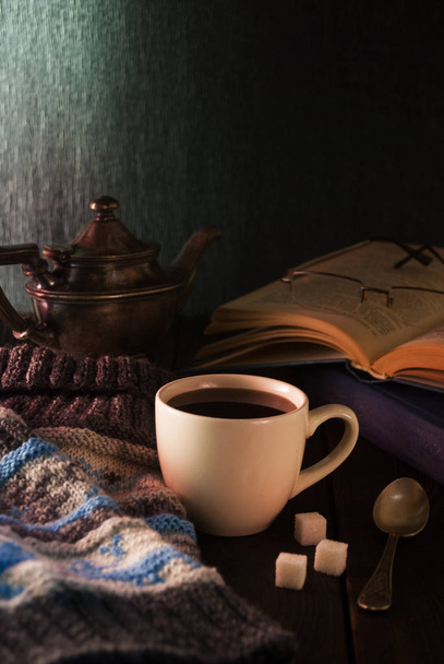 Cup of tea, book and knit cap on wooden a table - Photo, Image