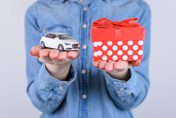 Concept of 8 march, valentine, winninng, lottery, luck, desiring getting real auto, give, idea, girlfriend, person, happiness, joke. Cropped close up view photo of arms opening box with car isolated - Photo, Image