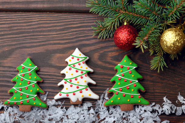 Gingerbread christmas tree on snow over wooden background.Copy space - Photo, Image