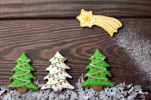 Gingerbread christmas tree on snow over wooden background.Copy space - Valokuva, kuva