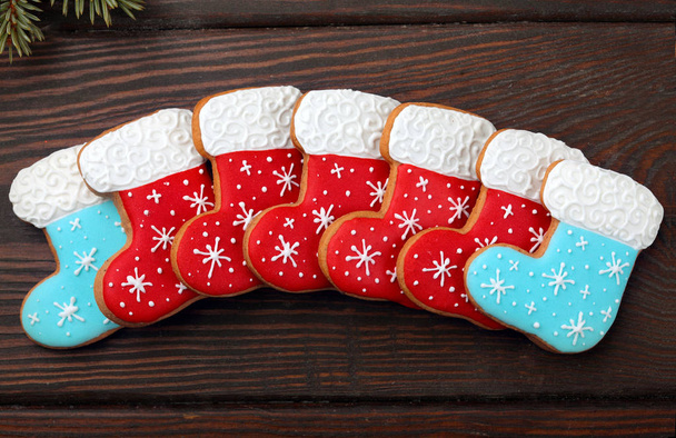 Gingerbread cookies boots over wooden background.Sweet Background.Closeup - Foto, imagen