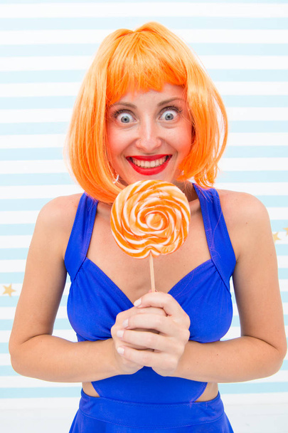 Cool girl with lollipop. Sexy woman. Fashion girl with orange hair having fun. happy pinup model with lollipop in hand. Crazy girl in playful mood. dieting. Sweet look. Enjoying sweet lollipop - Foto, afbeelding