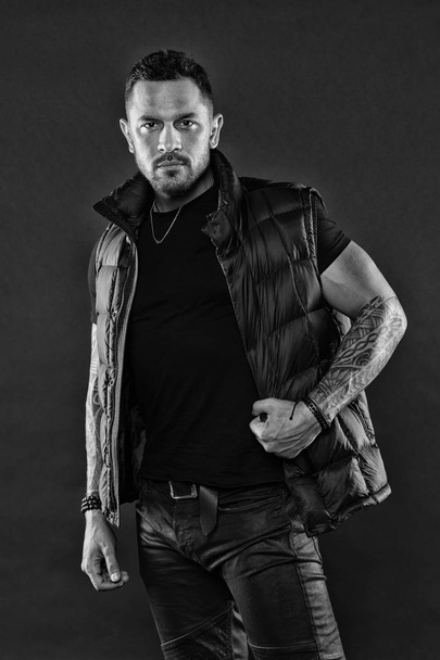 Tattoo brutal attribute. Tattoo art concept. Macho unshaven brutal wear vest. Man brutal unshaven hispanic appearance tattooed arms. Bearded man posing with tattoos. Masculinity and fashion concept - Fotoğraf, Görsel