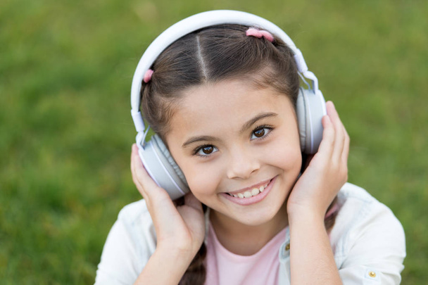 Autumn mood in headset for pretty girl. Happy little girl listen to music. Small child with happy smile. Casually beautiful. Happy childhood. Autumn snuggles. Carefree and so happy. Free your mind - Photo, image