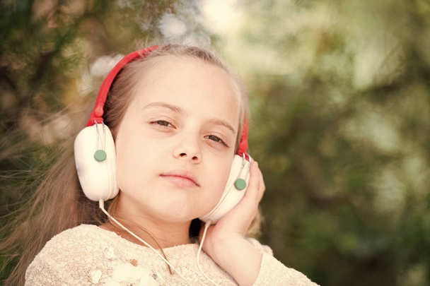 Cute little girl enjoying music using headphones - Foto, immagini