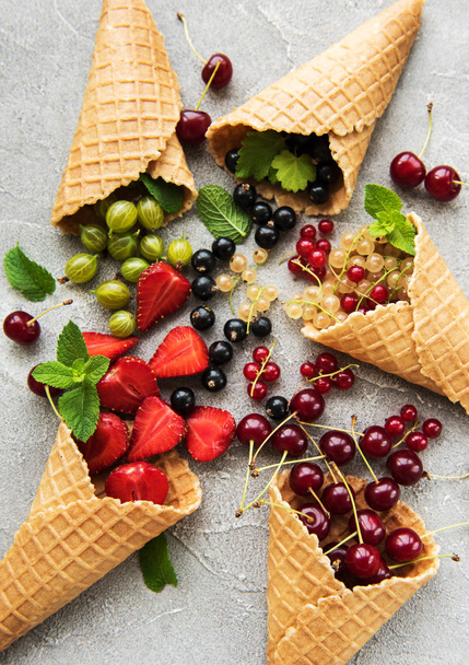 ice cream cone with berries on a stone background - Fotografie, Obrázek