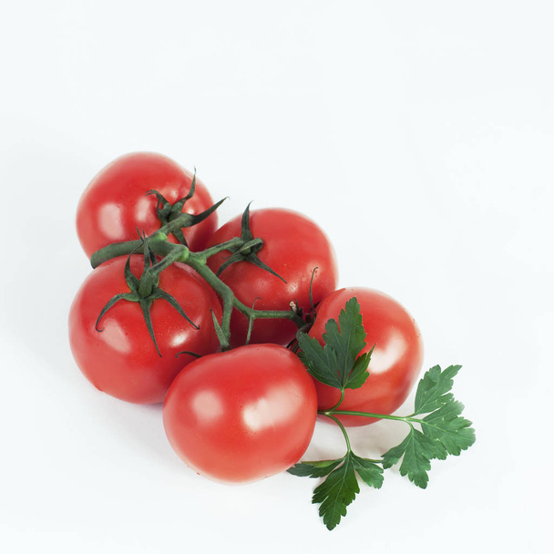 tomatoes on a branch .isolated white background - Fotó, kép