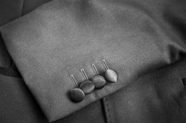 Buttons on the left sleeves of a grey blazer suit - Photo, Image